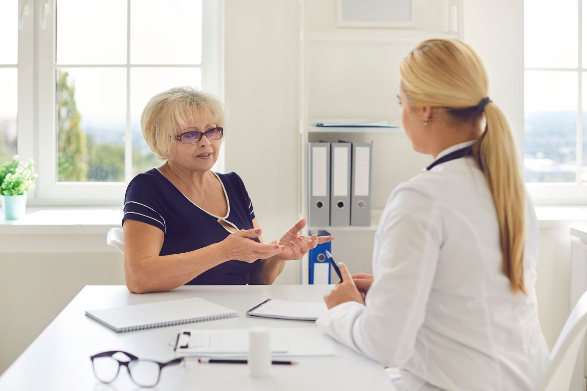 Medicare beneficiary talking about the 2025 Medicare premium updates with her doctor