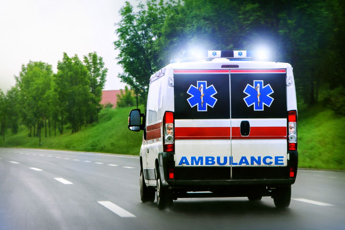 An ambulance racing down the road