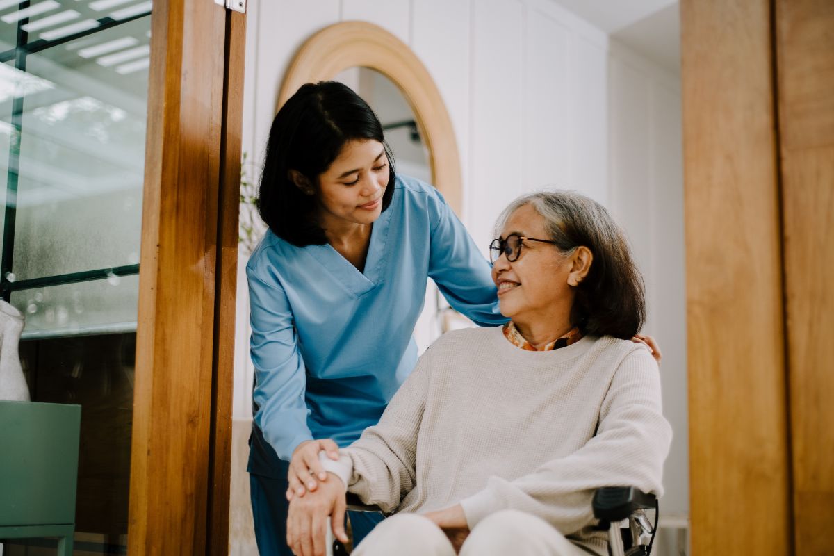 Healthcare worker helping a beneficiary at a skilled nursing facility